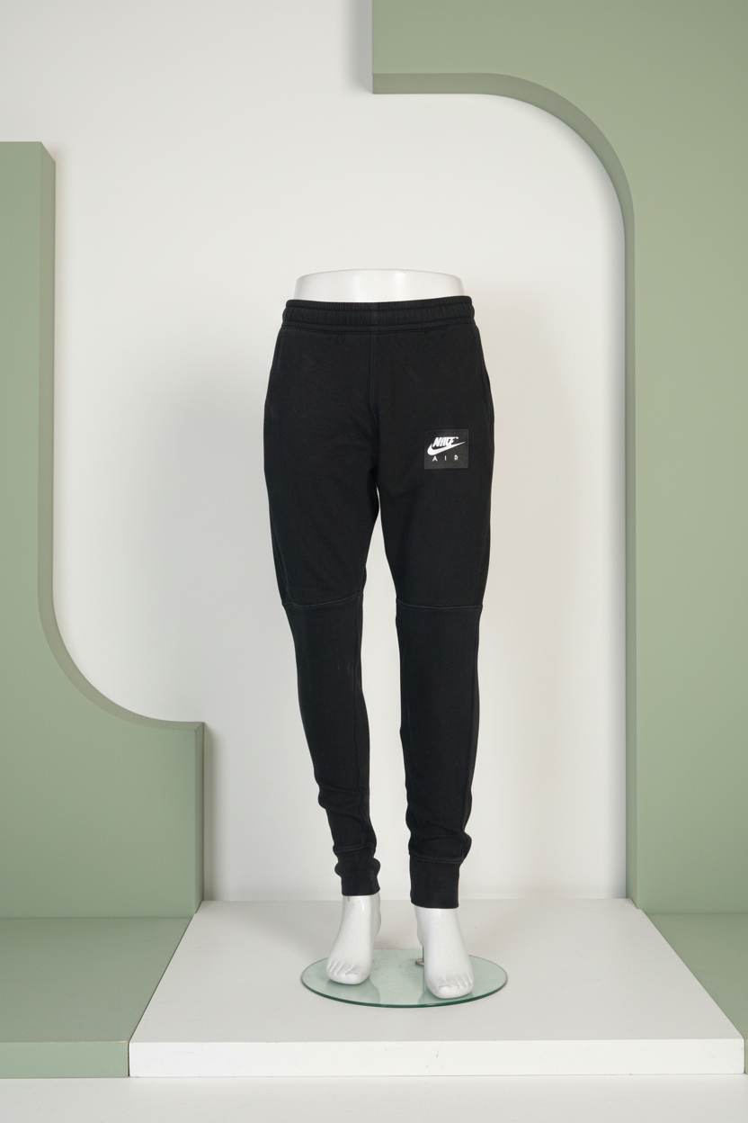 Black Nike jogger pants on a white background